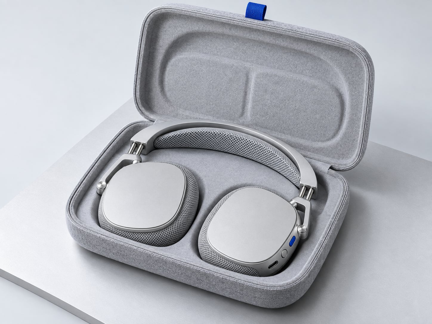 The Aura One travel case open, with the Frost silver headphones lying flat inside